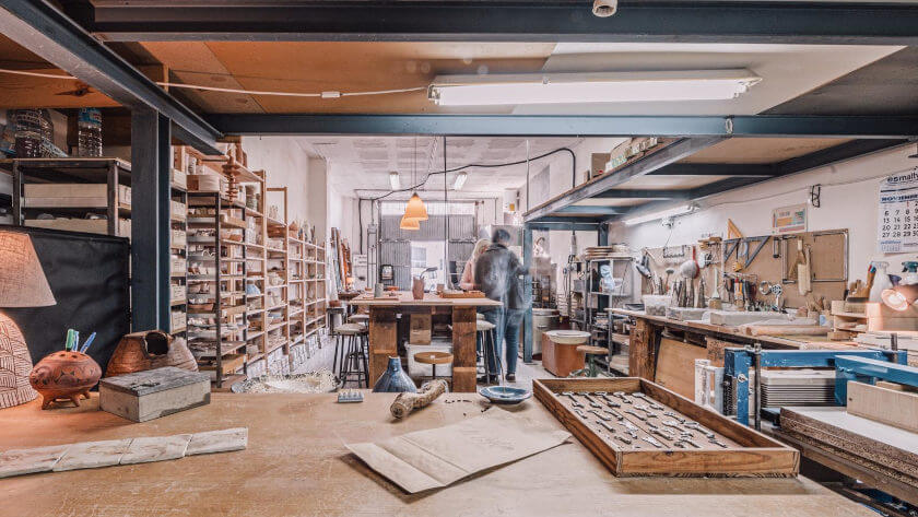 Al Zaytun's workshop with shelves, work tables and bright lights