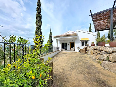 Entrance view of Casa Almendra in Alcaucín witha concrete terrace in front