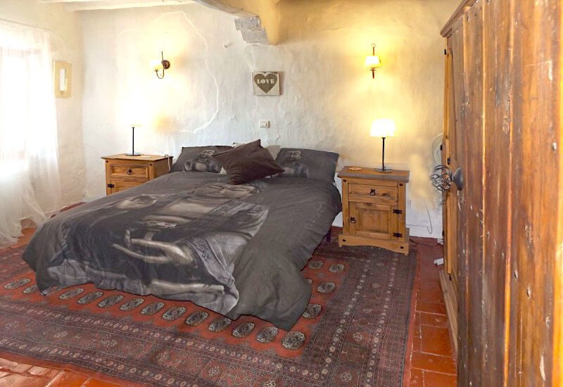 Huge master bedroom with a big wooden wardrobe.