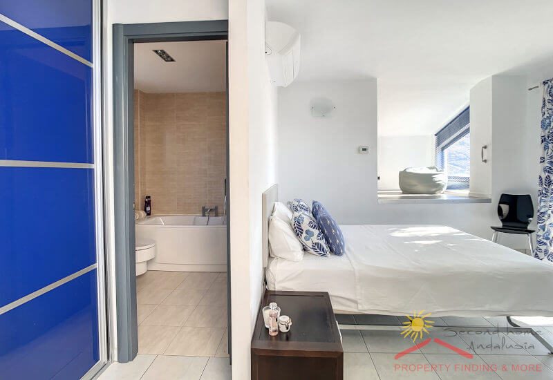 Bedroom 2 here with en-suite bathroom, bed and niche in the back.