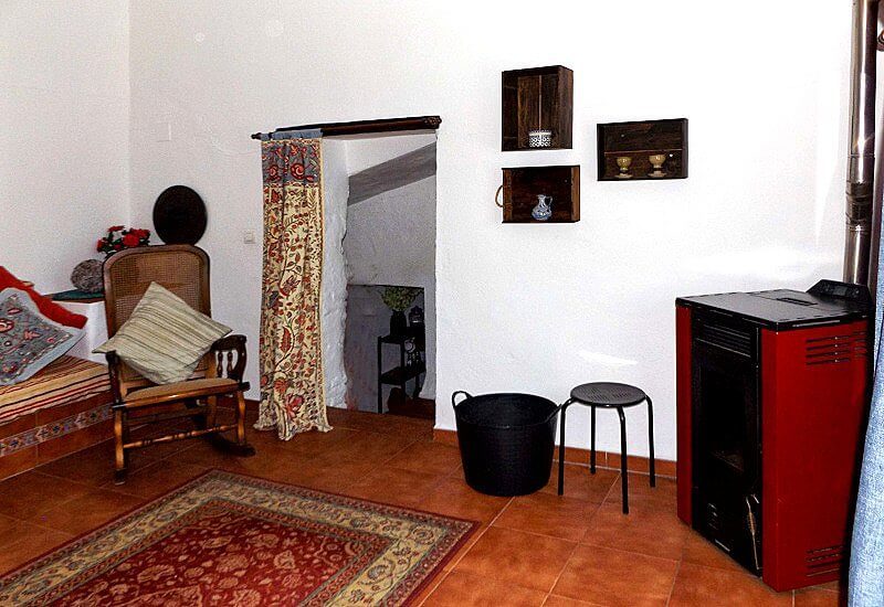 The Lounge on an upper floor has a log burner and the staircase leads downwards