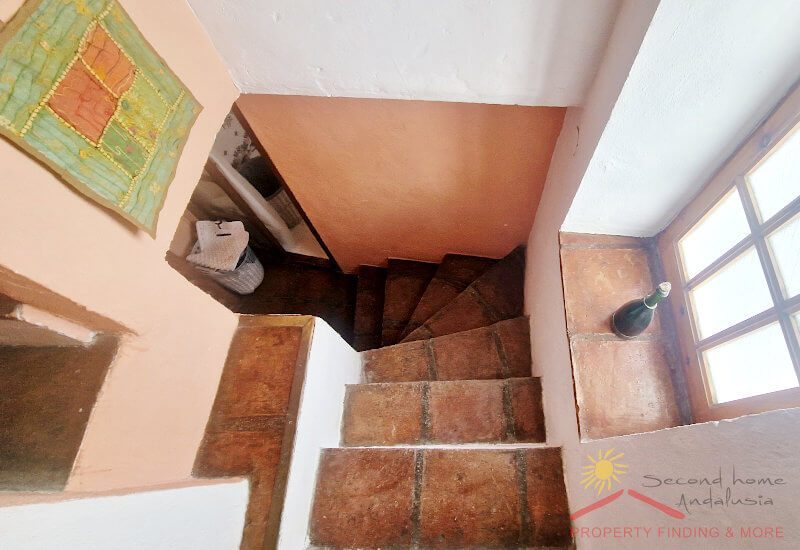 The staircase is steep and narrow but has a window