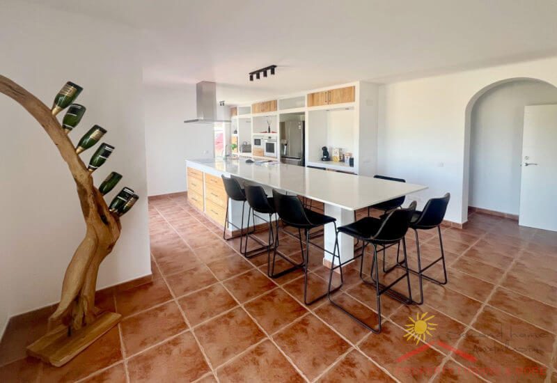The kitchen is connected to the living room through the dining area