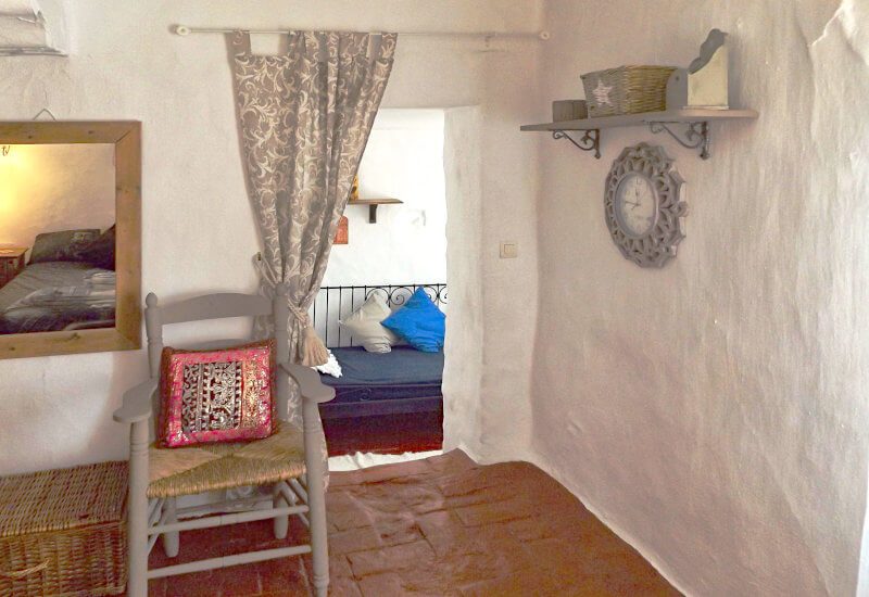 Master bedroom with entrance to an additional room with bed.