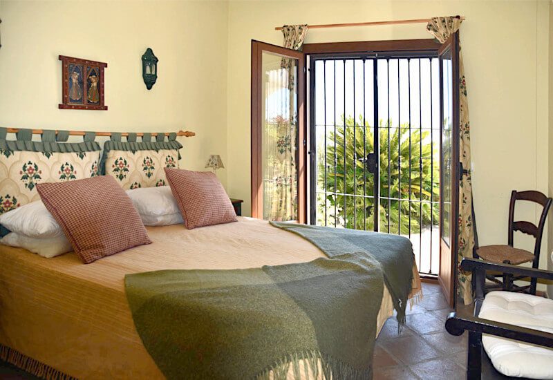 bedroom 3 with kingsize bed and big glass door towards the terrace