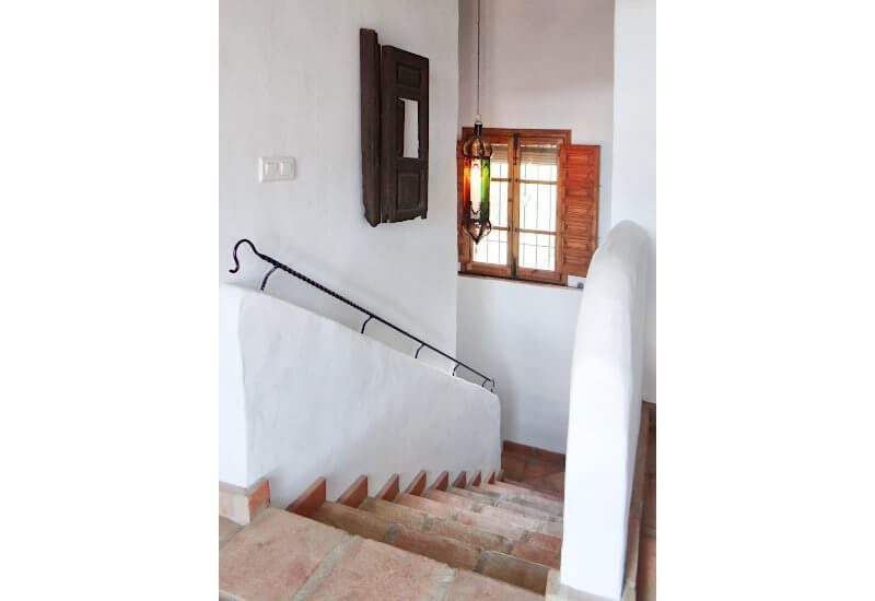 The staircase is wide and has a window