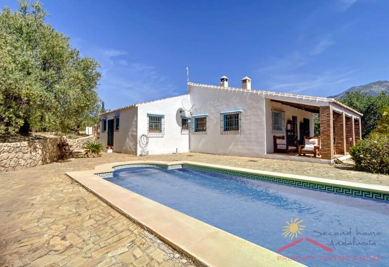 Casa Hennie for sale here with terrace and pool in front and the house behind in the sun