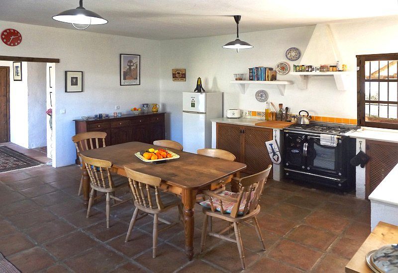 Wide kitchen with big table.