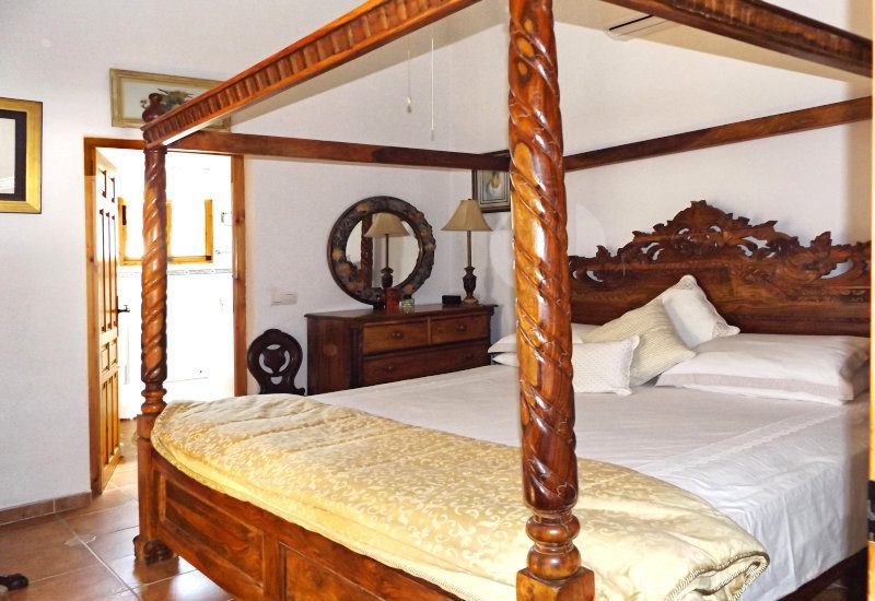 Master bedroom with a big double bed and a huge wardrobe.