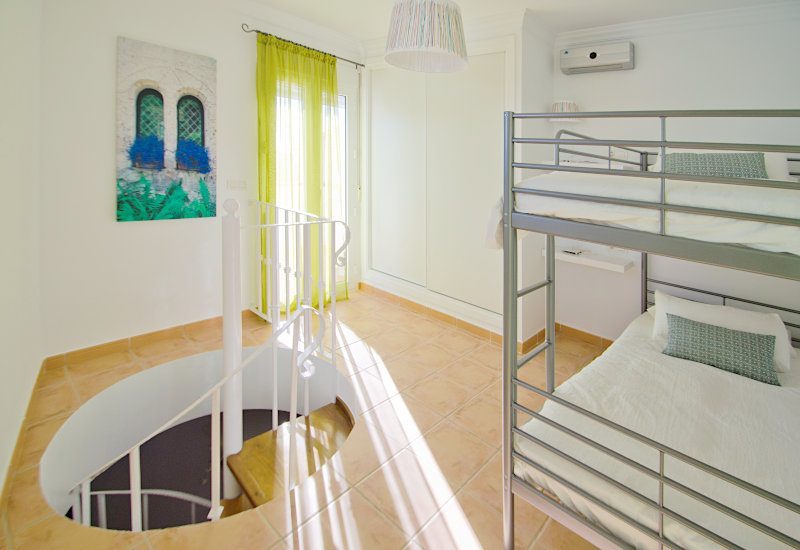 The second bedroom is located on the top floor and has access to the roof terrace