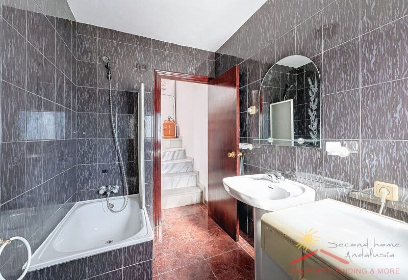 Moderne badkamer met bad en wasmachine