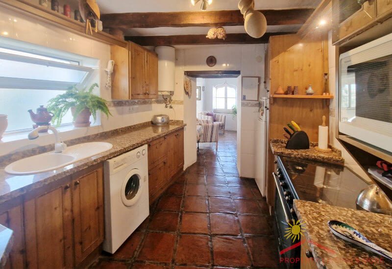 The kitchen is fully equipped and has a wide window