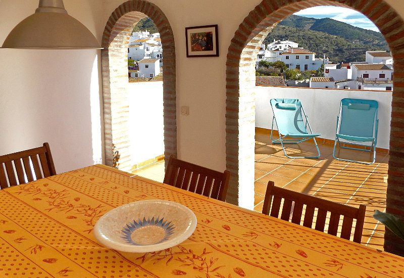 Roof terrace inner chamber with table and open to the sun roof.