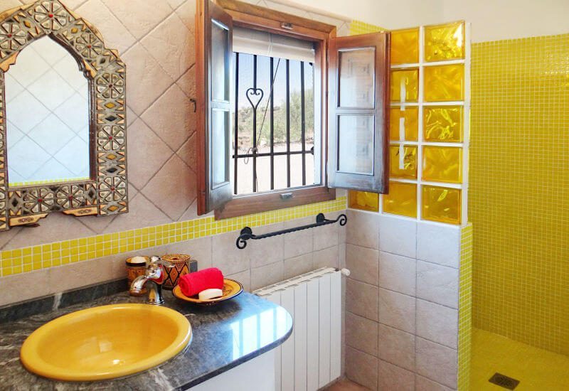 The yellow bathroom has its own window