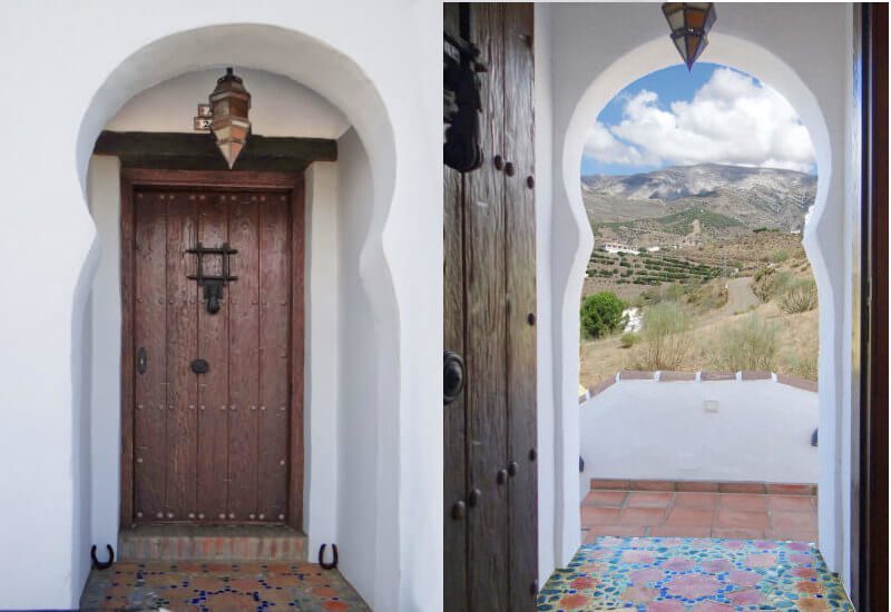 Chic entrance door made of wood in Moroccan style, from the entrance there is a phantastic view on the hills of the Axarquia