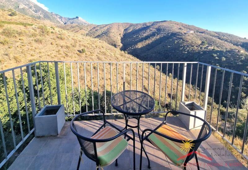The apartment terrace has table and chairs and offers a nice view over the landscape
