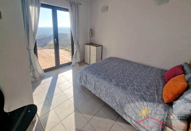 Bedroom 1 has a single bed and and access to the terrace via french doors and a nice view