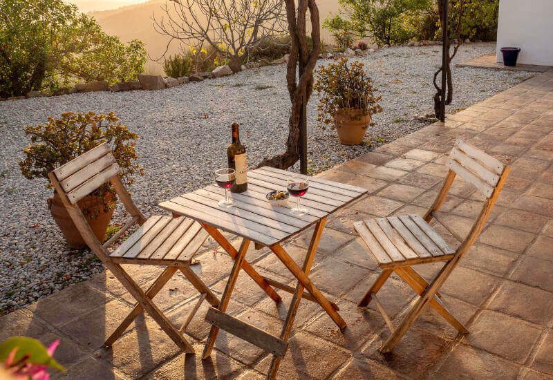 Terrace with chairs and table in the setting warm sun of Spain