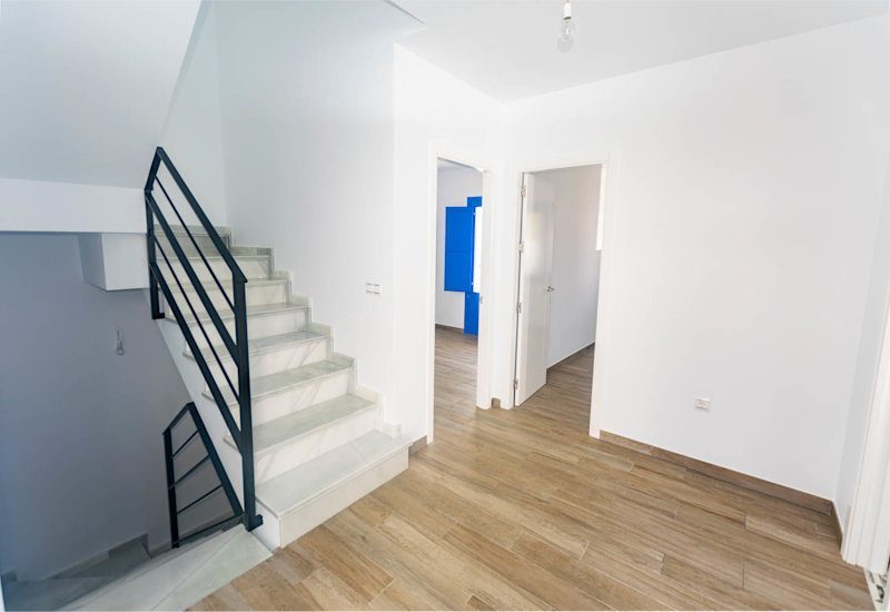 The entrance hall leads to the two bedrooms on this level and has staircase to upper and lower level.