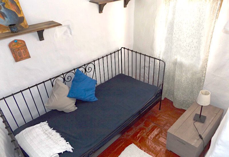 Master bedroom of casa Olivia in Sedella with additional room with bed and window