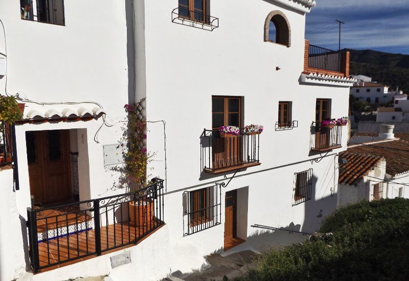 Front view of a spaceous townhouse for sale in Sedella.