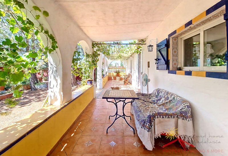 Covered side terrace with sofa and table