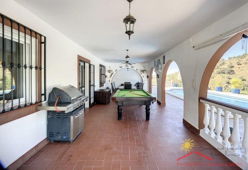 A big front porch has enough space for billiard table and barbecue