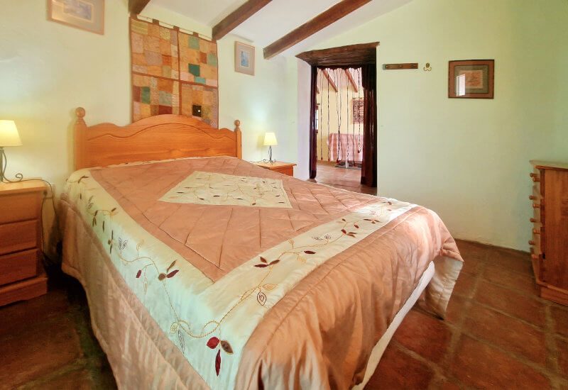 The guest room has a sloping roof and original wooden beams