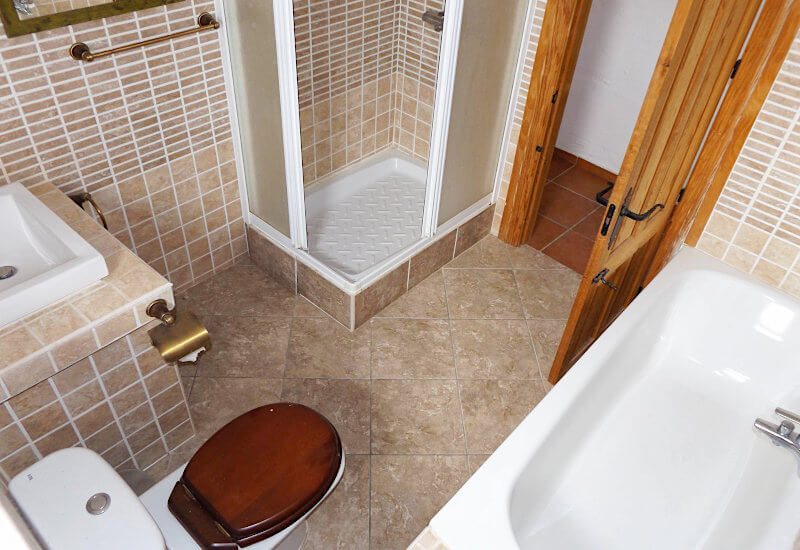 The bathroom is spacious with nice traditional tiles