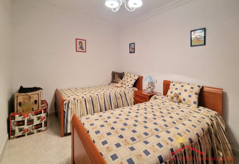 Twin bedroom with double bed without window