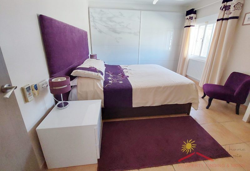 modern bedroom with kingsize bed and pitched in purple with a glass-door wardrobe, heating and a window