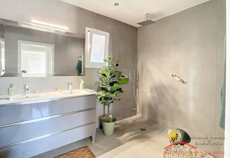 a modern, high-quality bathroom with a large shower area
