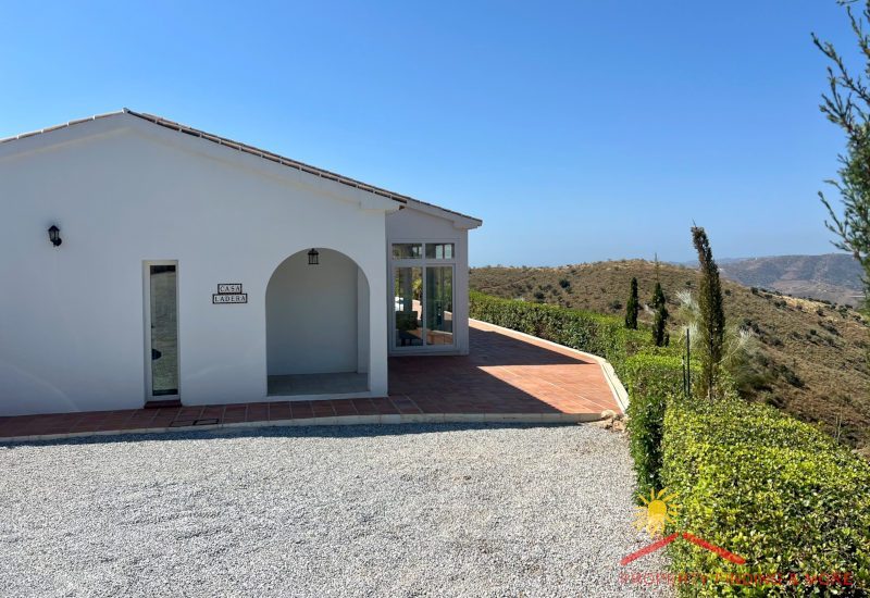 In front of the house is the entrance and parking area