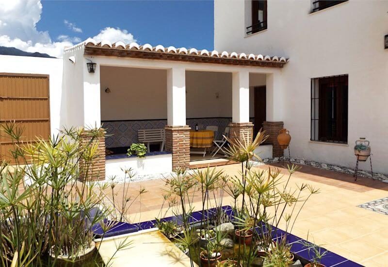 Courtyard with entrance and covered lounge and little pond