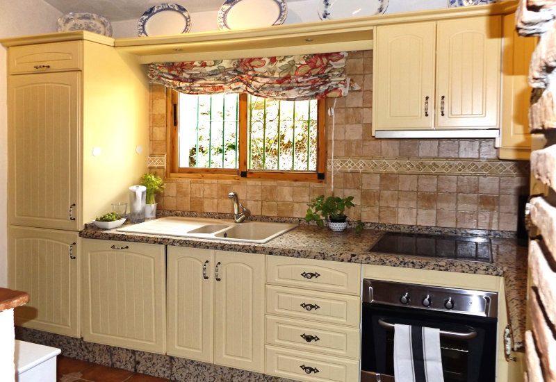Kitchen with sink and oven under the window.