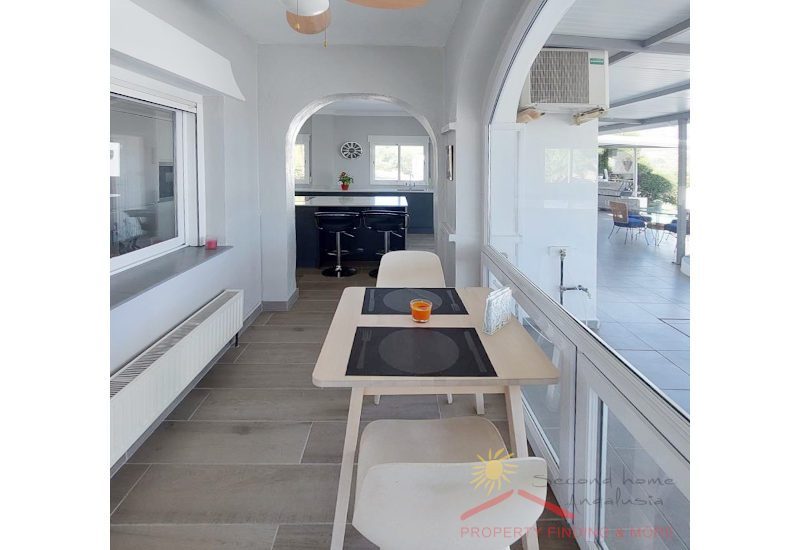 a heated passage from the kitchen with big glass window to the terrace is the breakfast nook