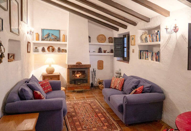 Cosy living room with fireplace and sloping beamed ceiling