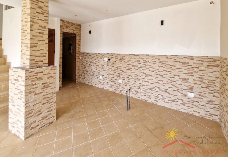 The swimming pool room has a place for loungers to relax