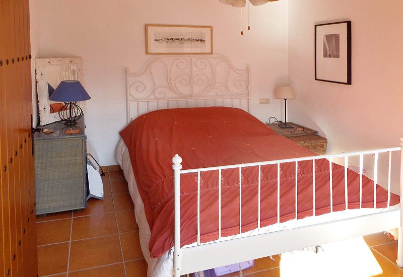 Bedoom 1 with natural light and king size bed.