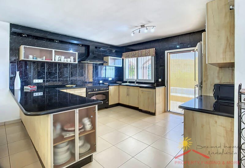 The kitchen is large and fully equipped with door to the terrace.