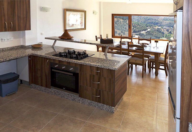 Large kitchen with gas oven and dining area.