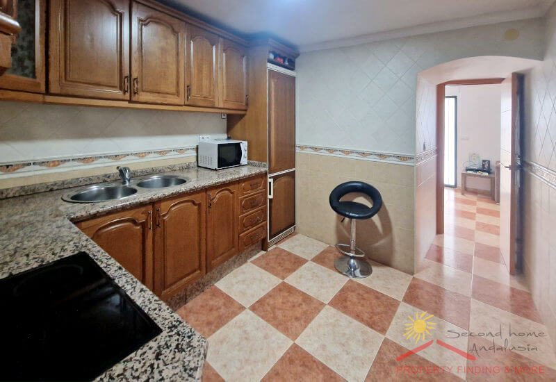 Fully equipped kitchen with access to the living room