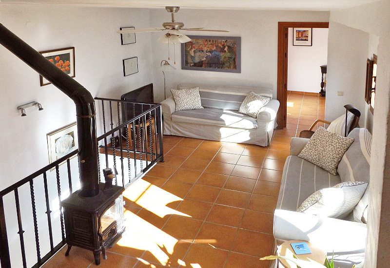 Lounge on the upper level with sitting area and television and oven.