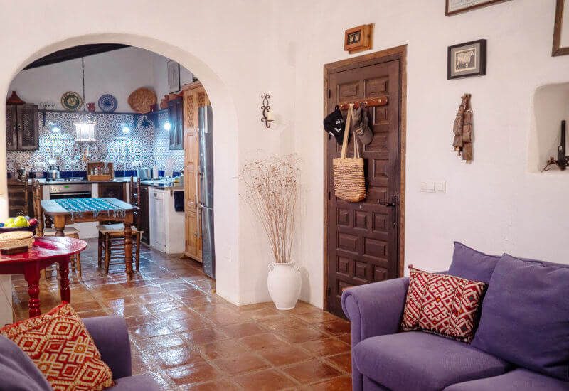 Photo of the entrance and fully equipped kitchen with dining table.
