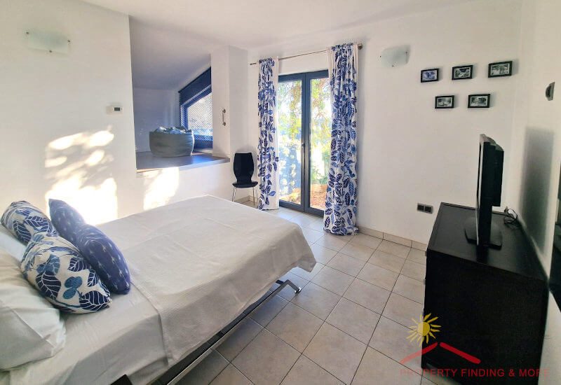 Bedroom 2 with a lot of space a a big single bed has french doors to the terrace