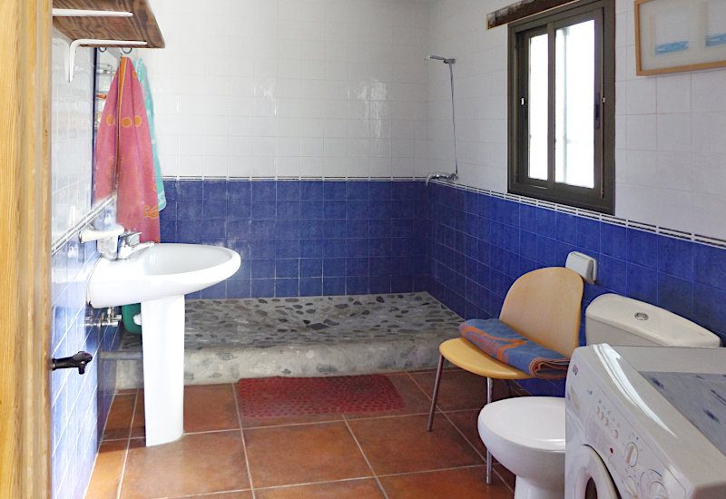 The shower room is spacious and has a window, with washing machine
