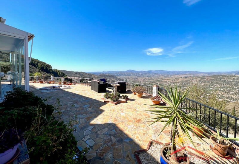 a bit terrace in front of the house with sitting area and a fantastic view over the Axarquía