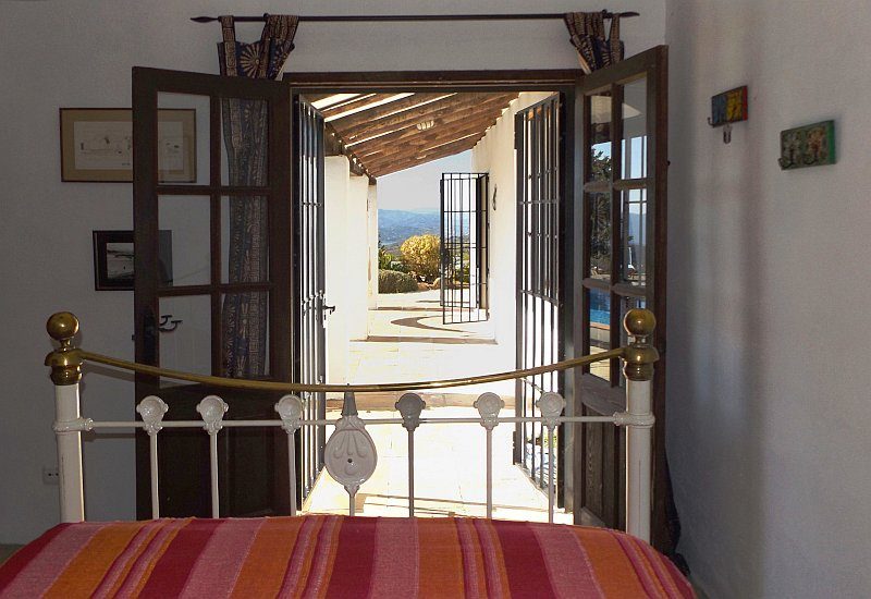 Photo of the guest bedroom with its open terrace door.