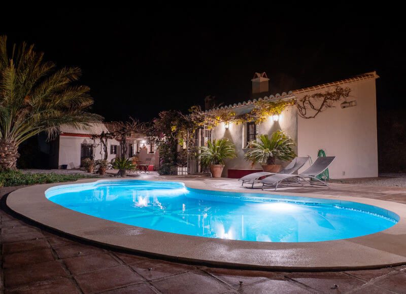 Lighted pool on the terrace in front of the house.