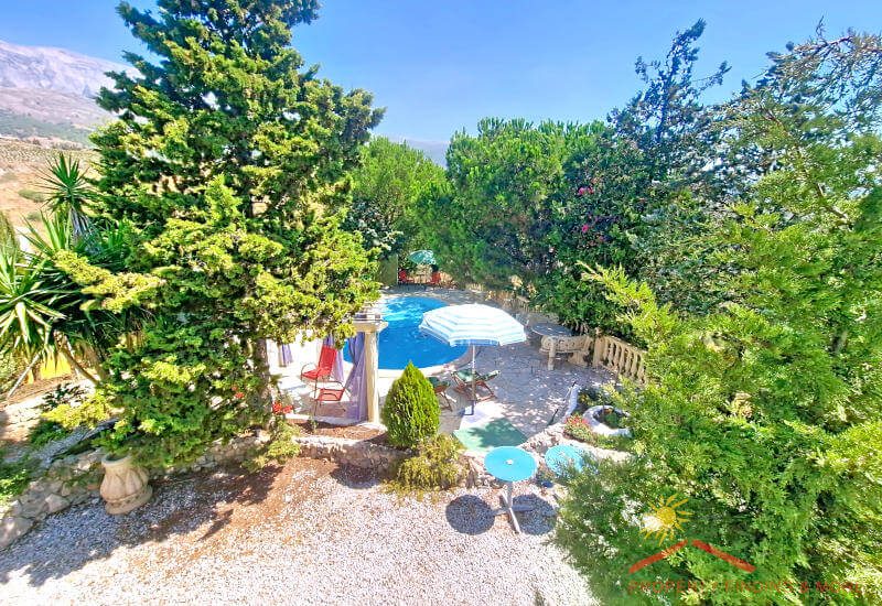 From the balcony, you can see the garden with terrace and pool, and Maroma in the background.